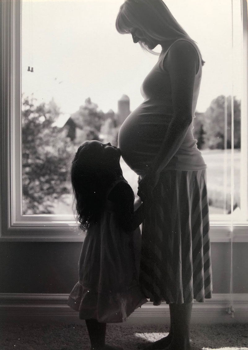 A pregnant woman and a little girl